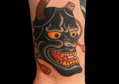 Japanese Traditional tattoo of a black hannya mask