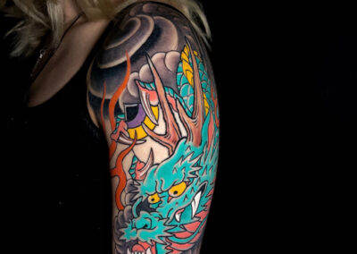 Japanese traditional tattoo of green dragon head with pink belly