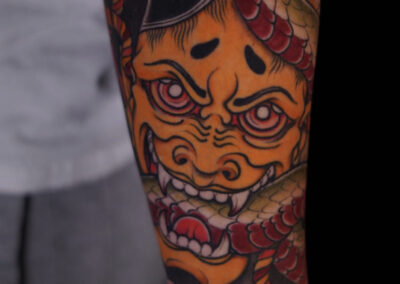 Japanese Traditional tattoo of hannya mask biting snake full sleeve