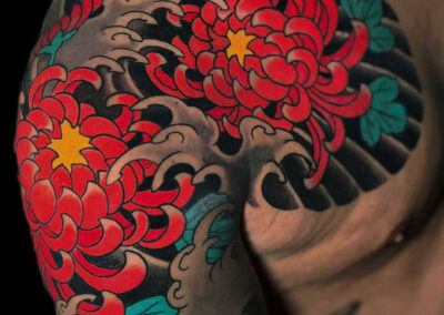 Japanese traditional tattoo of red chrysanthemums quarter sleeve and chest panel