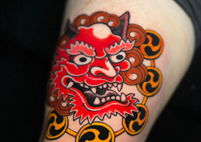 tattoo of red oni head with drums