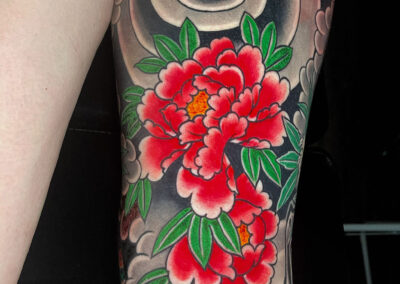 Japanese traditional tattoo of red peonies and windbars