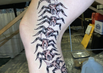 American traditional tattoo of centipede made of teeth