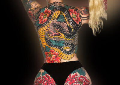 Japanese traditional tattoo back piece cover up of black snake and red peonies on glutes