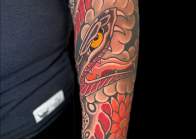Japanese Traditional tattoo of open mouth snake with chrysanthemums
