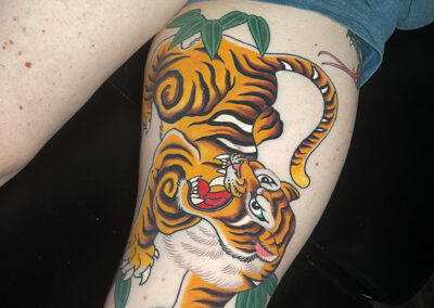 Japanese Traditional tattoo of a full body open mouth tiger on leg