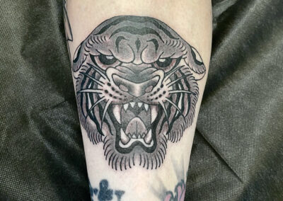 black an gray tiger head tattoo