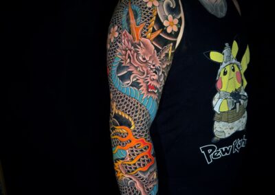 Japanese traditional black dragon with blue belly full sleeve tattoo