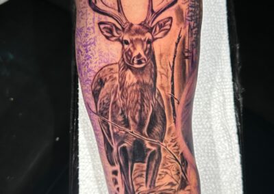 black and gray male deer tattoo