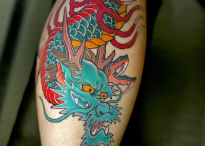 Japanese traditional tattoo green dragon head with flames tattoo