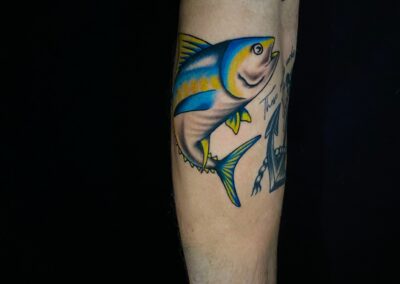blue and yellow fish tattoo