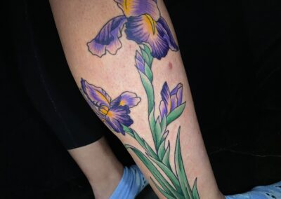 iris flower tattoo on leg