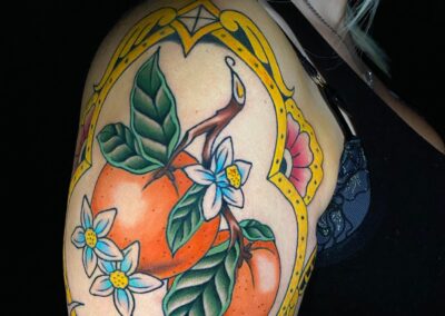 oranges and orange blossoms tattoo on arm