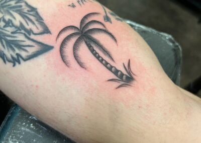 small black and gray palm tree tattoo