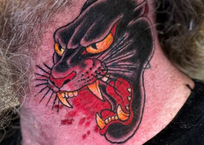 American traditional open mouth panther head on neck tattoo