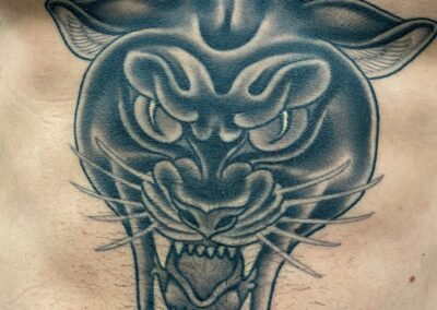 American Traditional black and gray panther head tattoo on stomach
