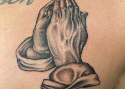 black and gray praying hands tattoo