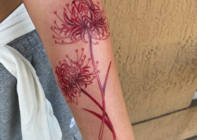 red flowers with red outline tattoo