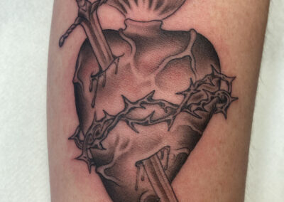black and gray sacred heart with dagger and thorns tattoo
