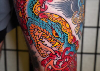 Japanese traditional open mouth snake with red chrysanthemum tattoo