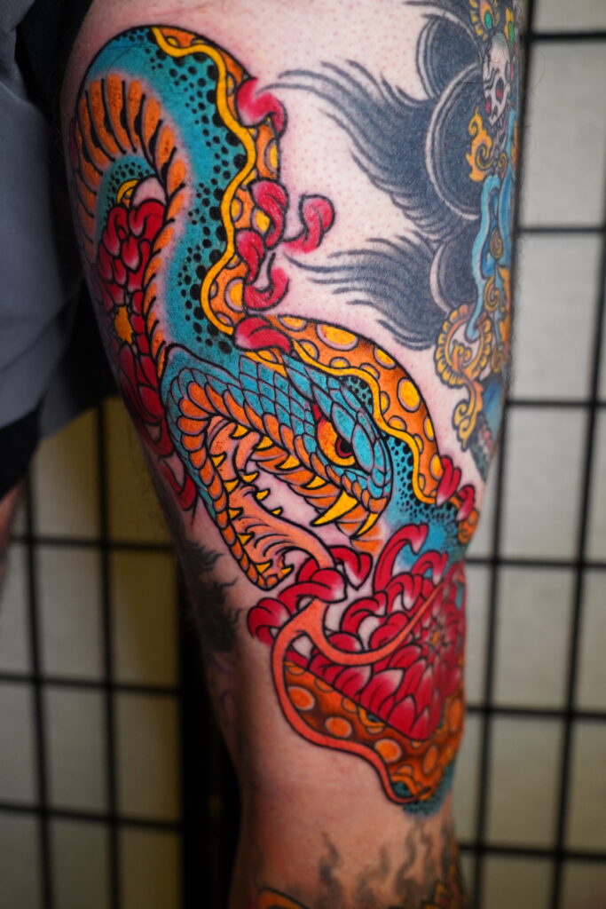 Japanese traditional open mouth snake with red chrysanthemum tattoo