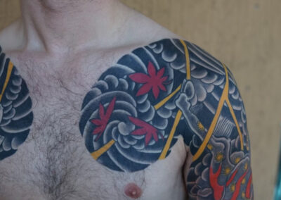 double chest panel tattoo of wind bars and lightning